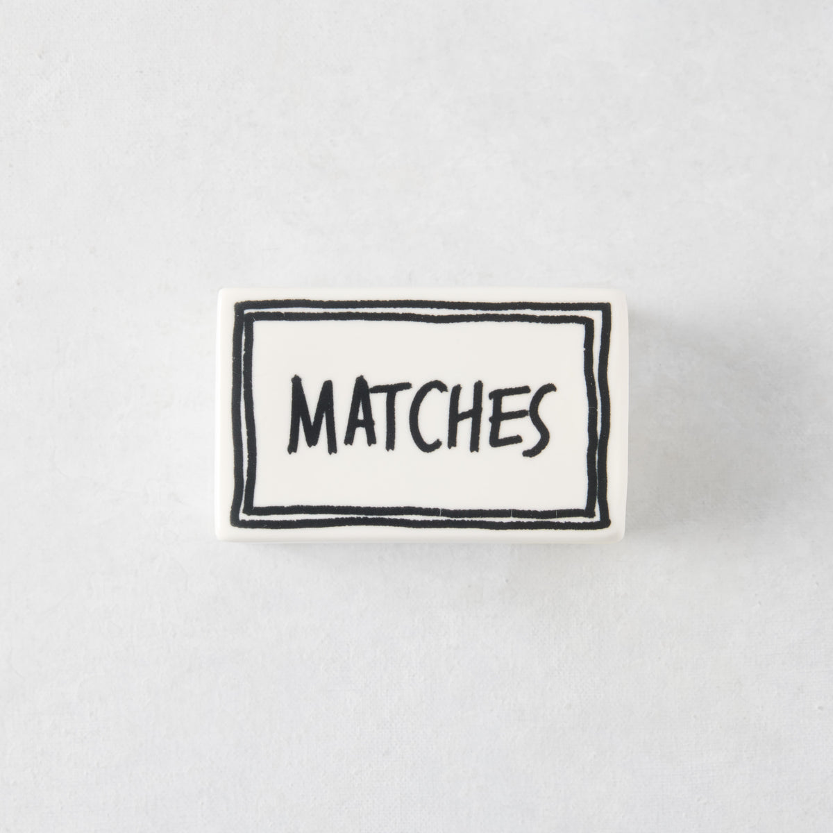 White porcelain match box with hand-painted black border and the word MATCHES in a whimsical font.