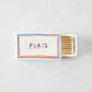 White porcelain match box with red and blue border, Paris text, and wooden matches, 3.54 x 2.17 inches.