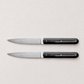 Set of two Perceval 9.47 steak knives with stainless steel blades and dark, polished pakkawood handles.