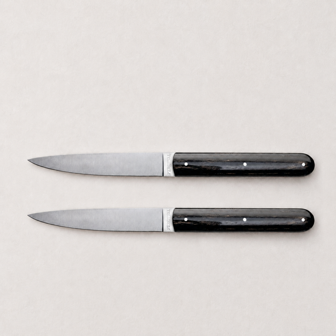 Set of two Perceval 9.47 steak knives with stainless steel blades and dark, polished pakkawood handles.