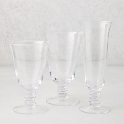 Three clear Palermo stemmed water glasses of varying heights, hand-blown glass with curved lips and artistic stems.