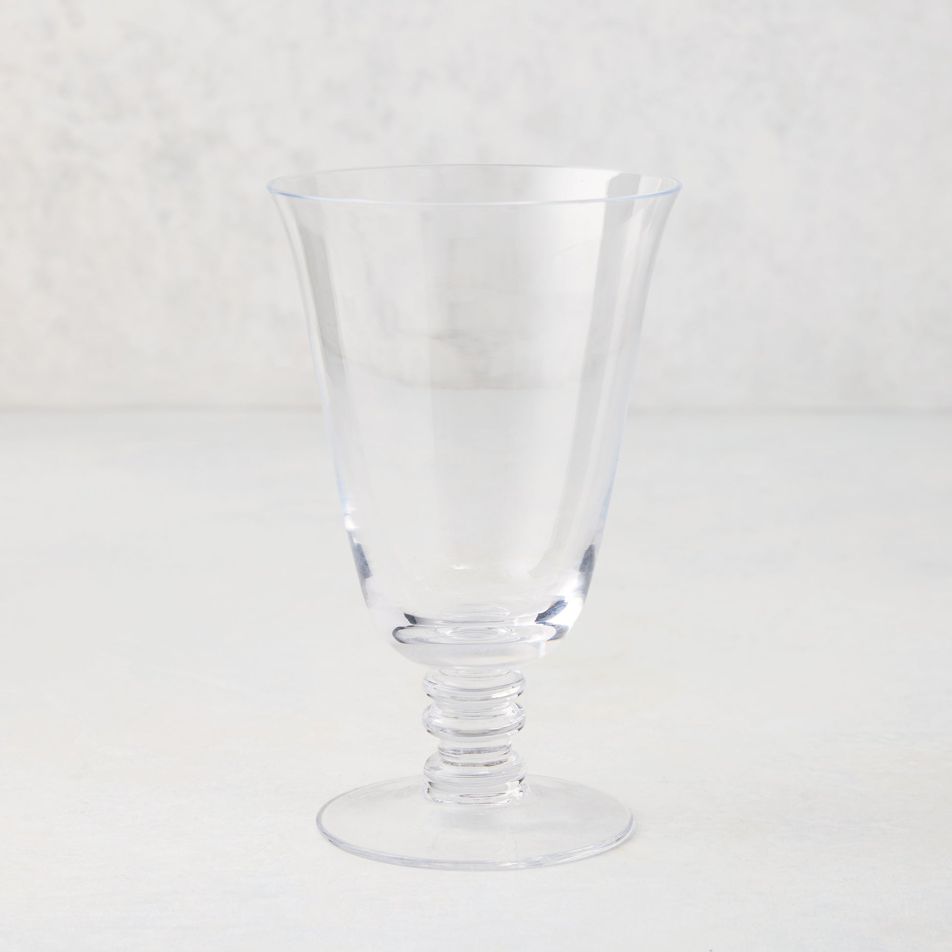 Palermo Stemmed Water Glass, clear hand-blown glass with curved lip and artistic ribbed stem.