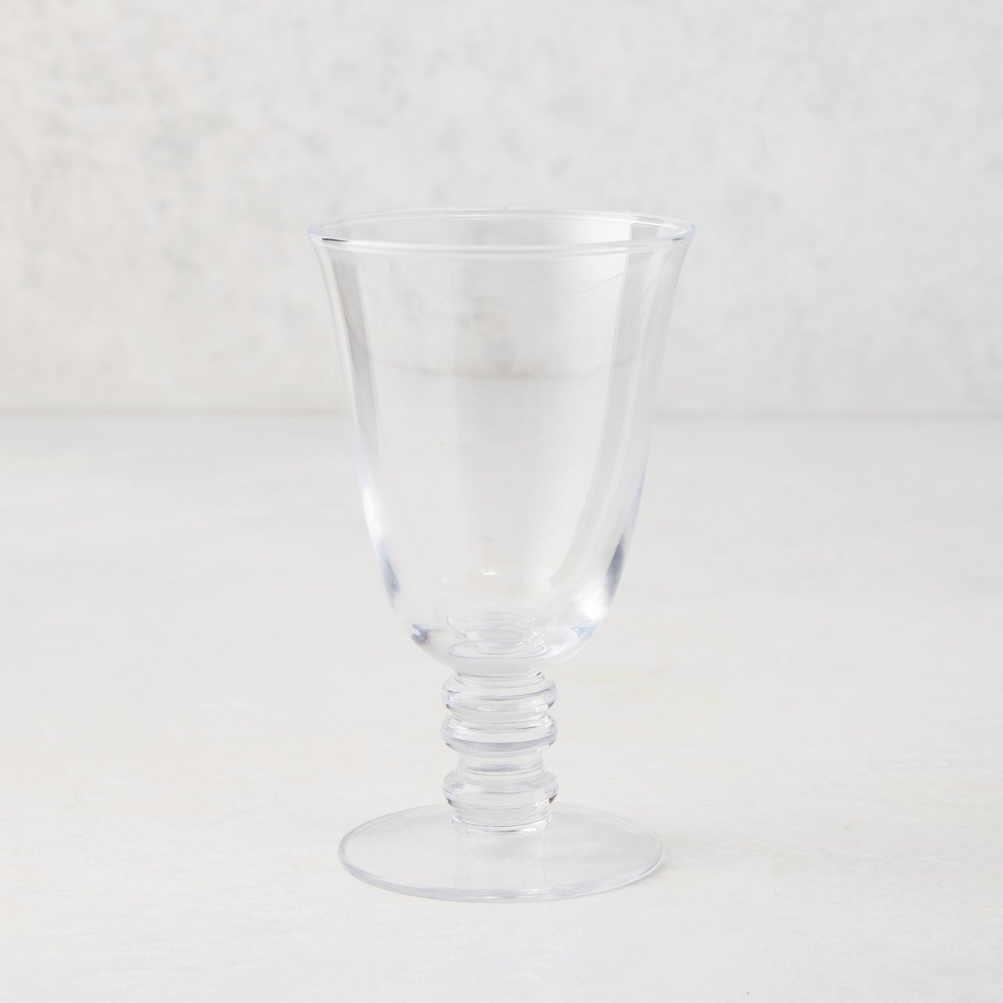 Clear Palermo stemmed wine glass, hand-blown glass with curved lip and artistic ribbed stem.