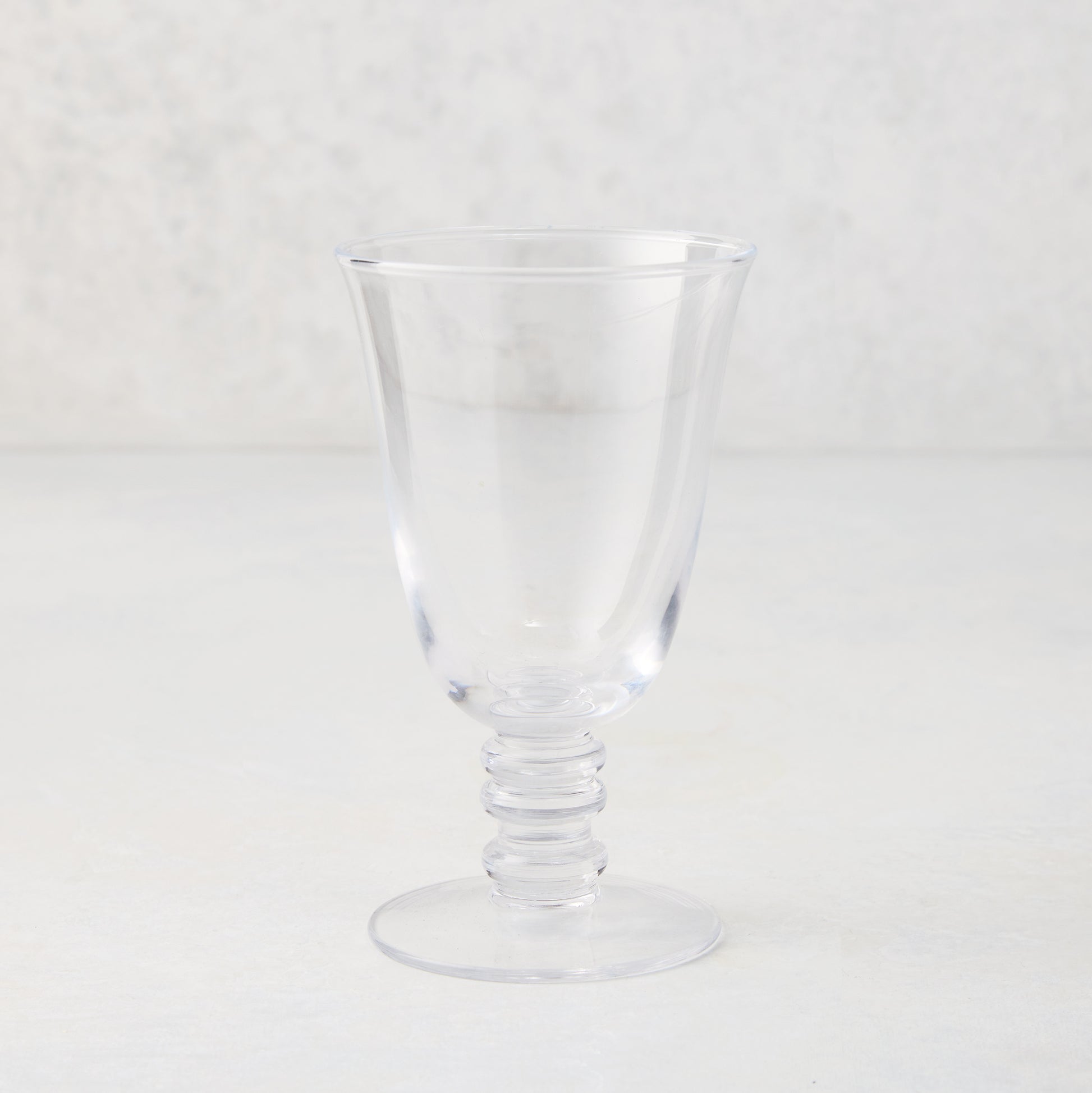 Clear Palermo stemmed wine glass, hand-blown glass with curved lip and artistic ribbed stem.