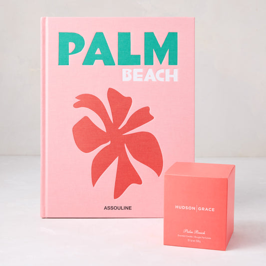 Assouline Palm Beach hardcover book with pink cover next to a coral Hudson Grace scented candle box.