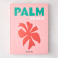 Pink hardcover "Palm Beach" book with green and white title, coral palm leaf graphic, and Assouline logo.