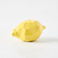 Glazed paper mache decorative lemon, 2"Dia x 3.4"L, with a textured yellow finish.