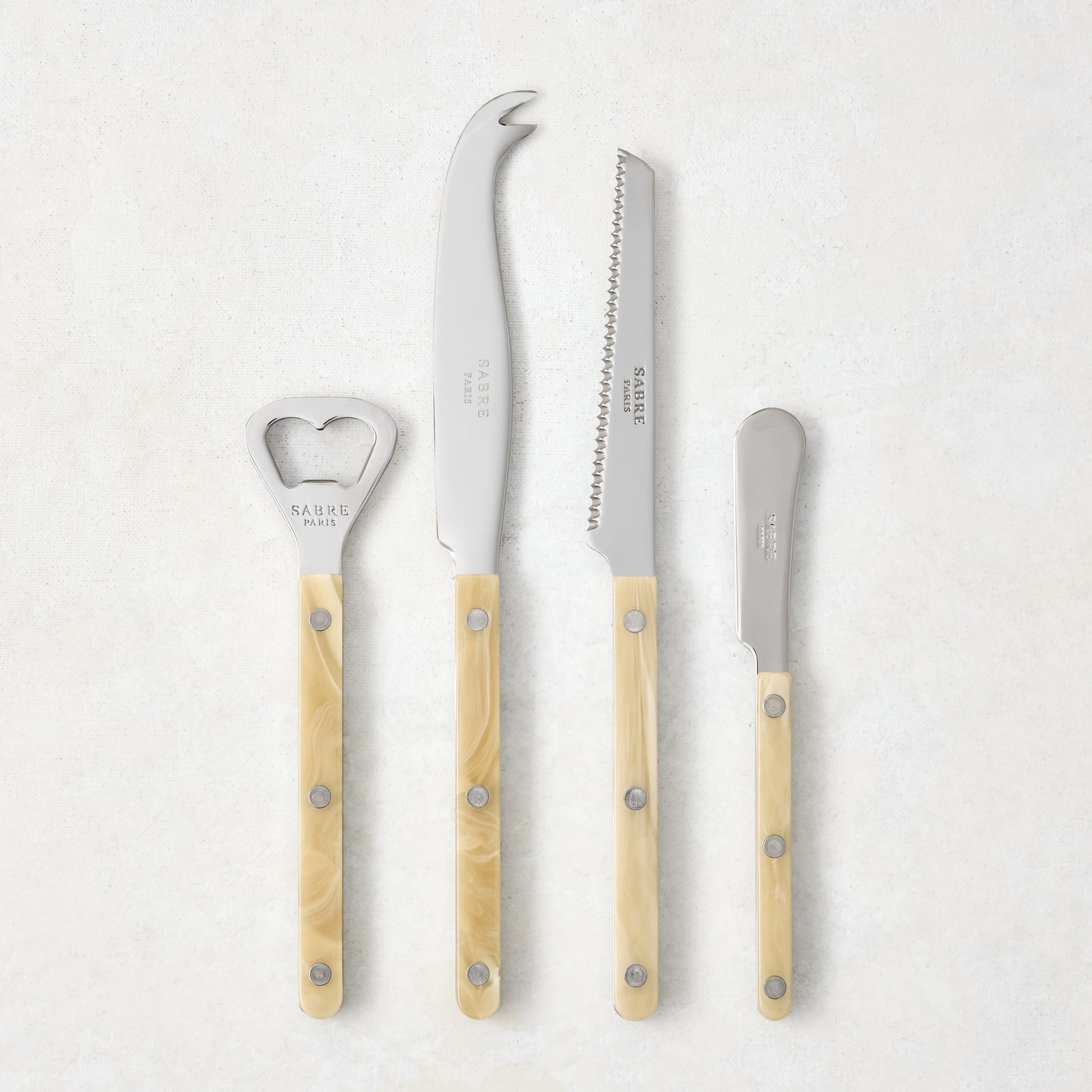 Paris Bistro Aperitif Set: 18/10 stainless steel bottle opener, tomato knife, cheese knife, butter spreader with cream acrylic handles.