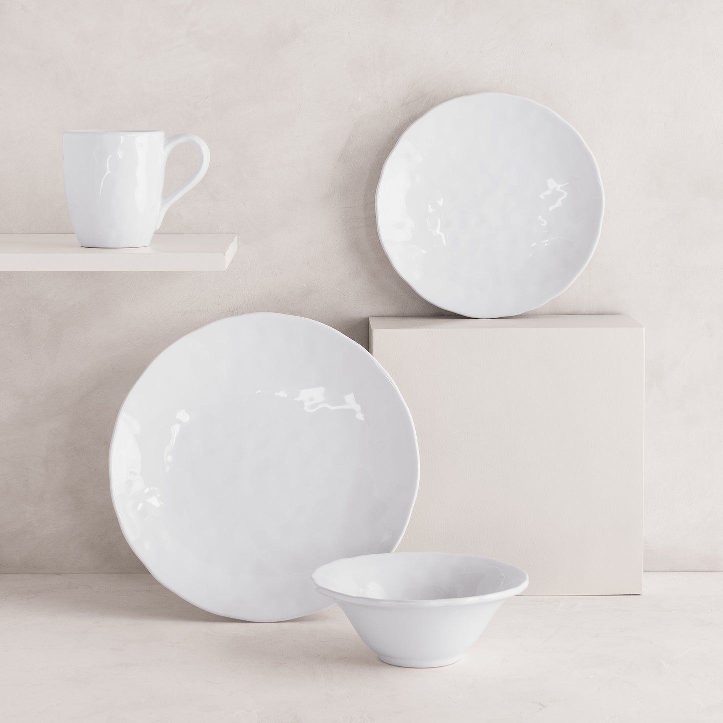 Pebble White ceramic mug, dinner plate, salad plate, and bowl with subtle textures.