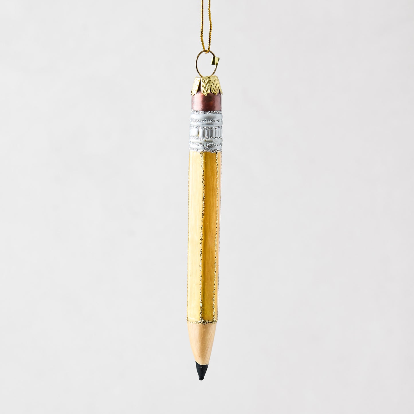 Hand-painted glass pencil ornament with yellow body, silver glitter accents, and a gold hanging loop.