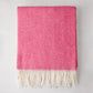 Peony Pink Italian Herringbone Throw Blanket, cashmere-soft cotton-acrylic blend, with white fringe.