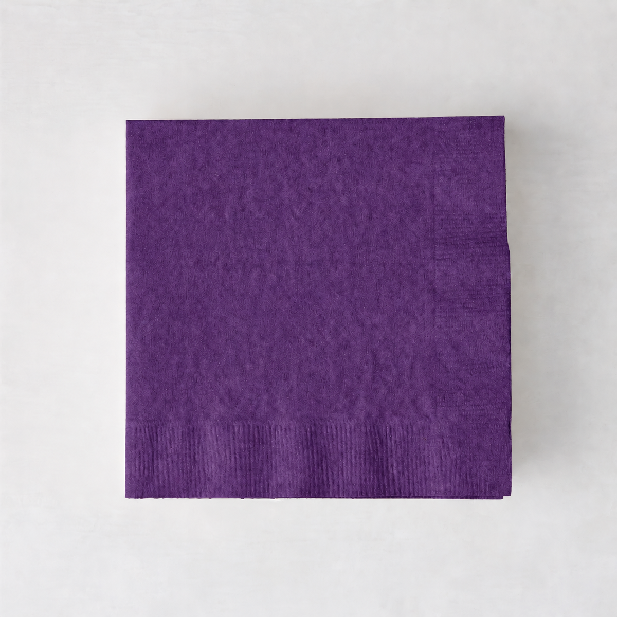 Square dark purple 3-ply paper cocktail napkin with embossed border detail.