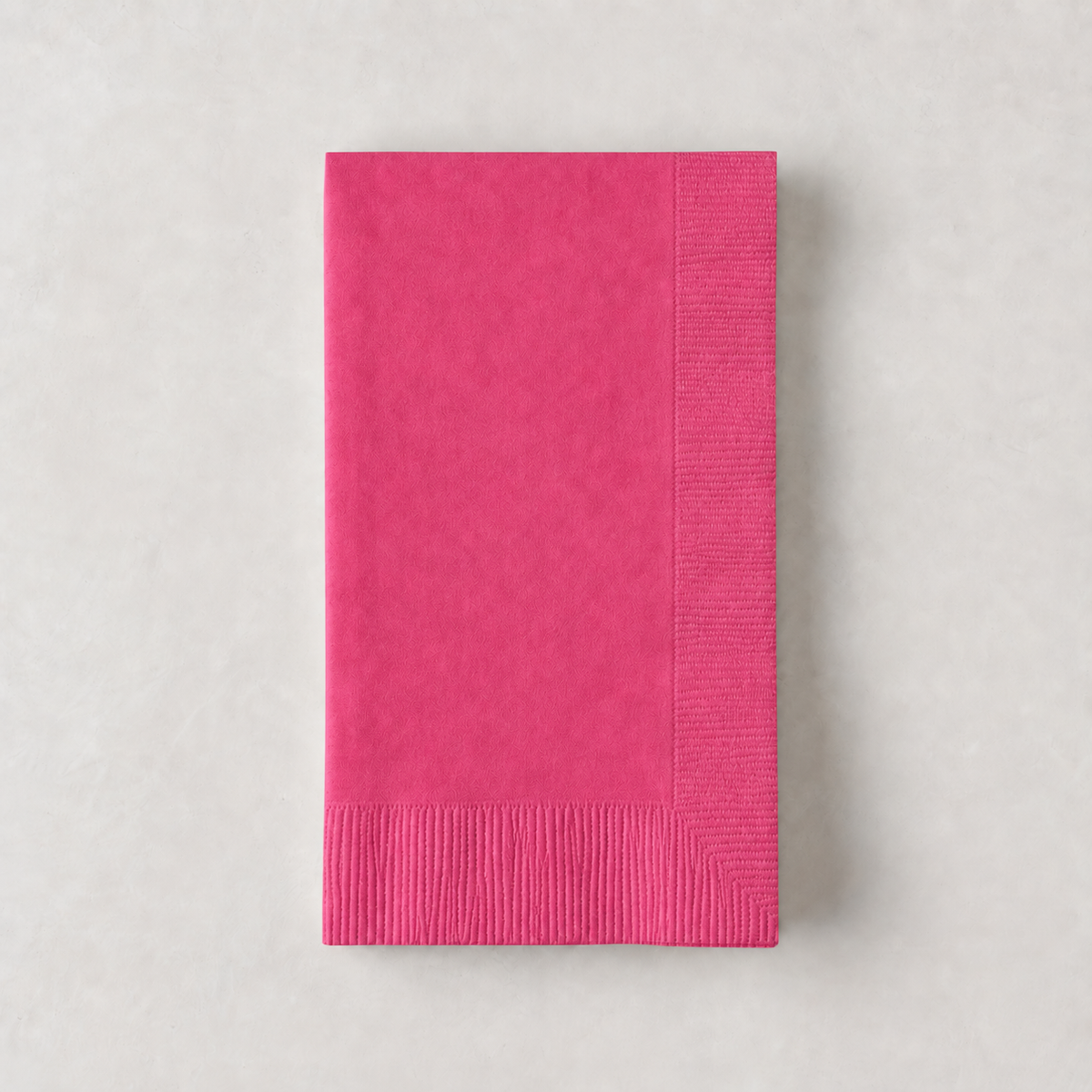 Magenta pink 3-ply disposable paper hand towel with a textured border, 8 by 4.5 inches.