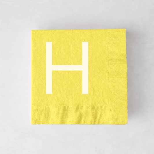Personalized pale yellow 5.5-inch square paper cocktail napkin with a white letter H monogram.