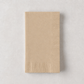 Folded tan paper hand towel with a textured border on a light grey background.