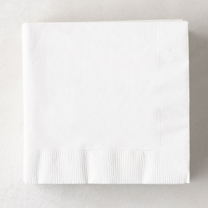 Stack of white, 3-ply disposable paper cocktail napkins, 5.5" square.