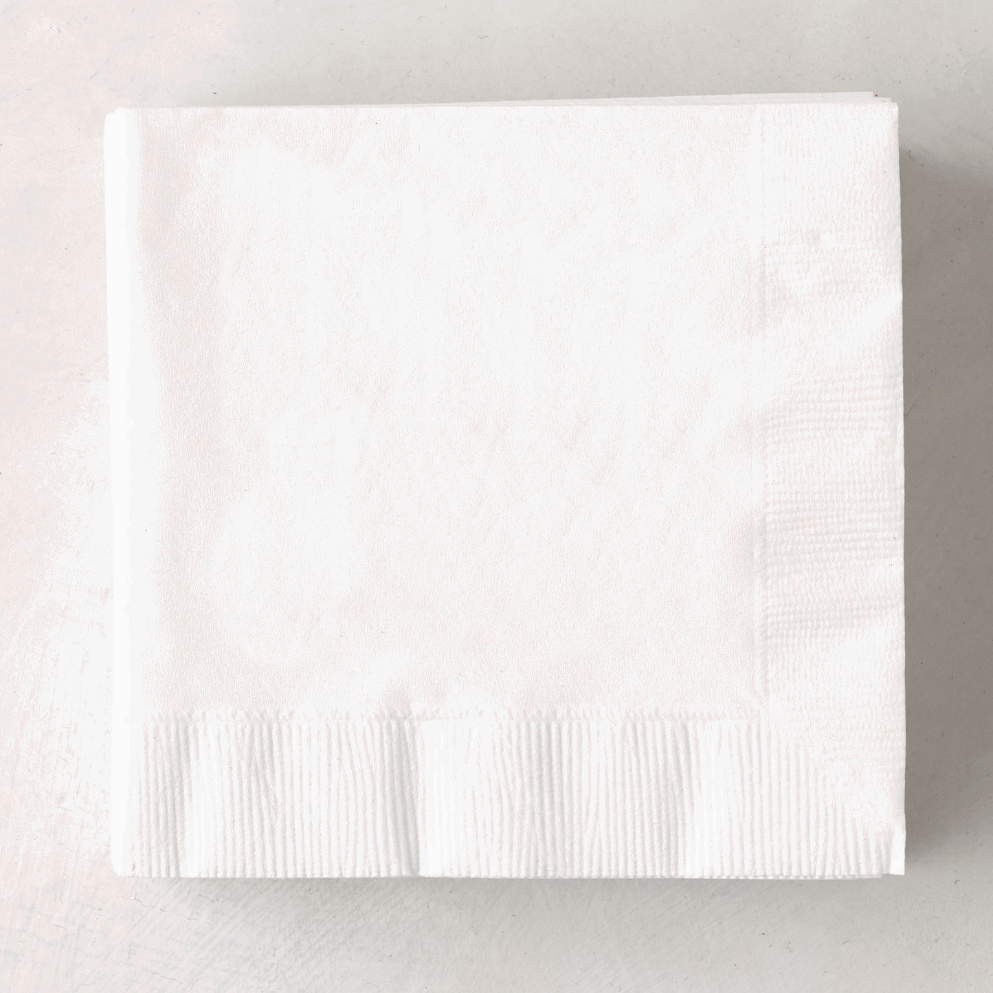 Stack of white 3-ply disposable paper cocktail napkins, 5.5" square.