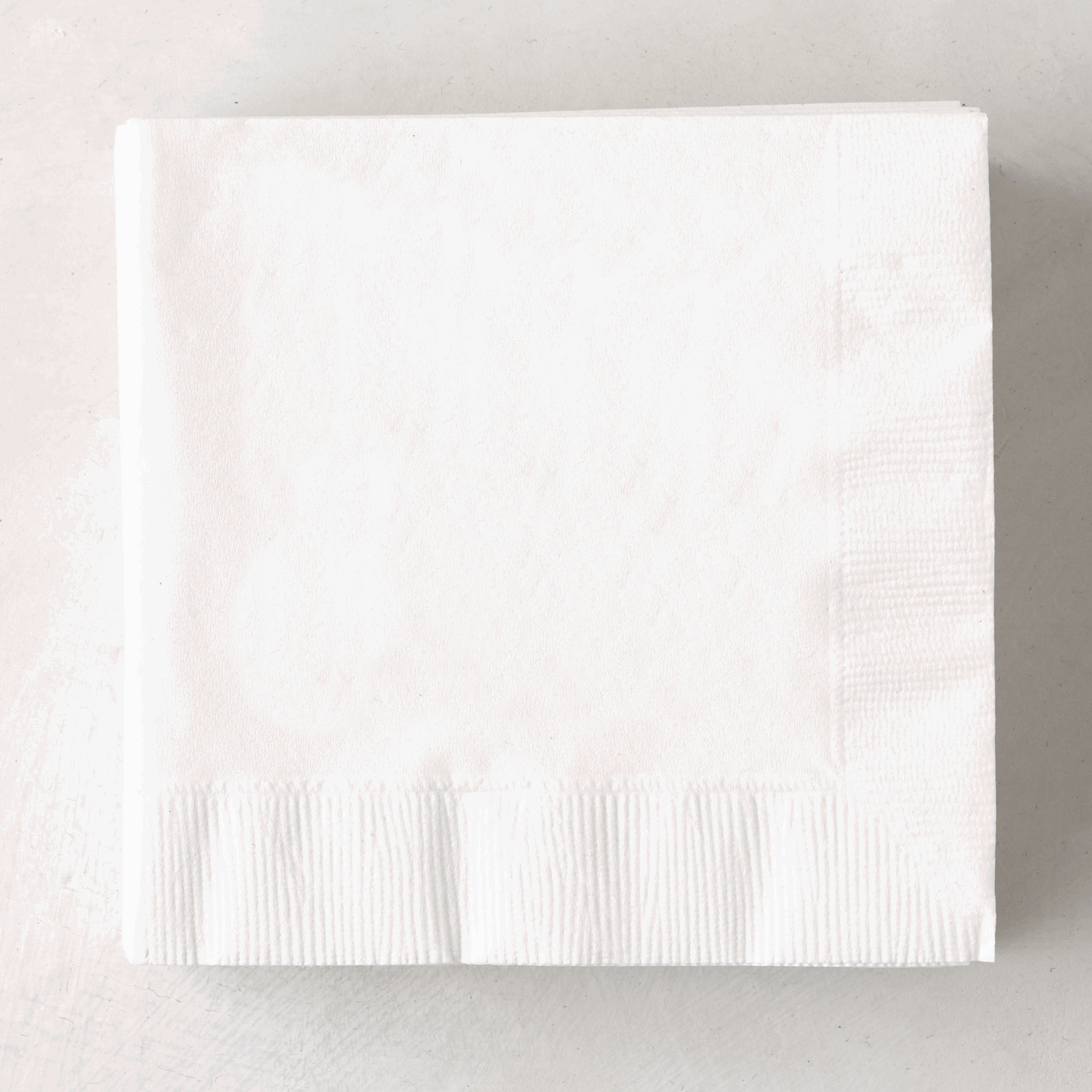 Stack of white 3-ply disposable paper cocktail napkins, 5.5" square.