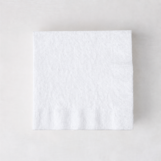 Square 5.5-inch white 3-ply paper cocktail napkin with a textured border on a light background.