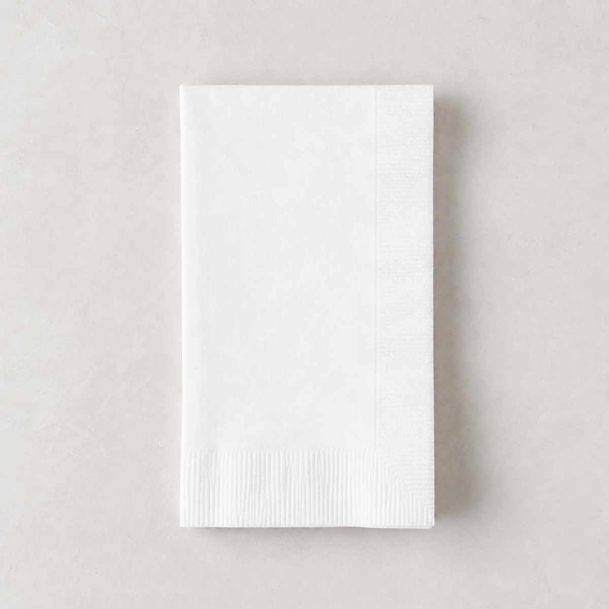 Folded white 3-ply paper hand towel with a textured border, 8 by 4.5 inches.