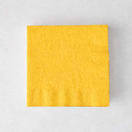 Square yellow 3-ply paper cocktail napkin on a white background.