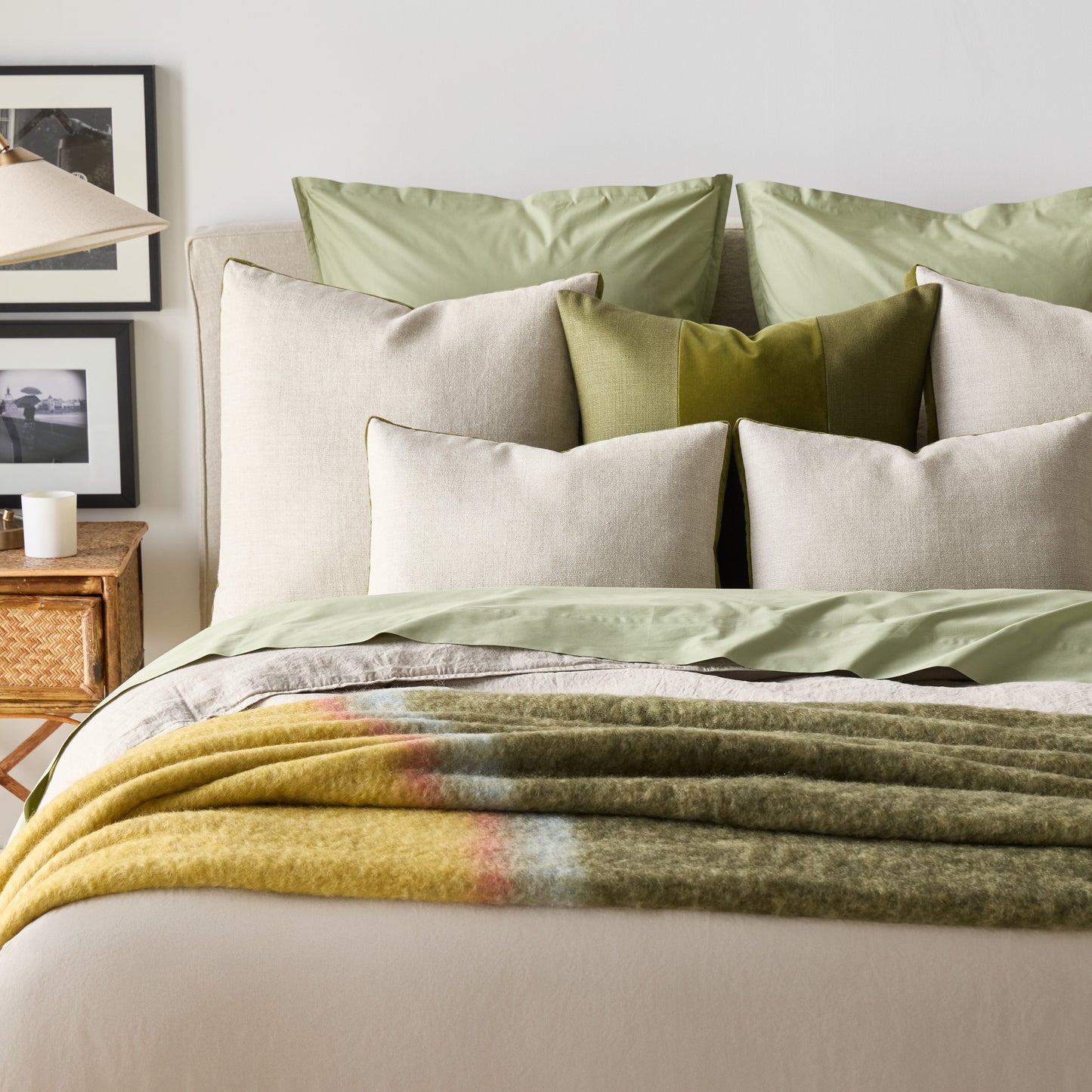 Pesto green velvet and natural linen square pillow with gusset, 22" square, on a bed.