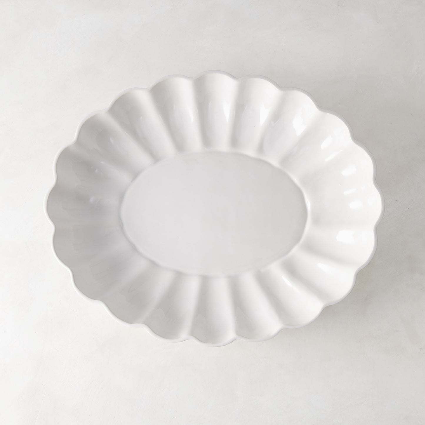White Petal Large Oval Ceramic Serve Bowl with scalloped edges and glazed finish.