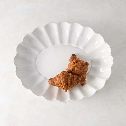 White Petal Large Oval Ceramic Serve Bowl with two croissants.