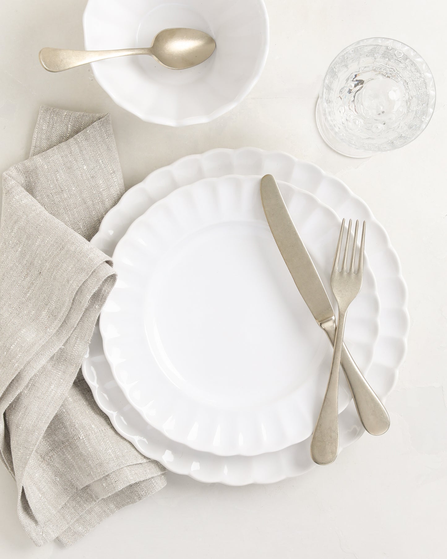 White Petal Stoneware Dinner Plate, 11.25" diameter, with matching salad plate, bowl, and silverware.