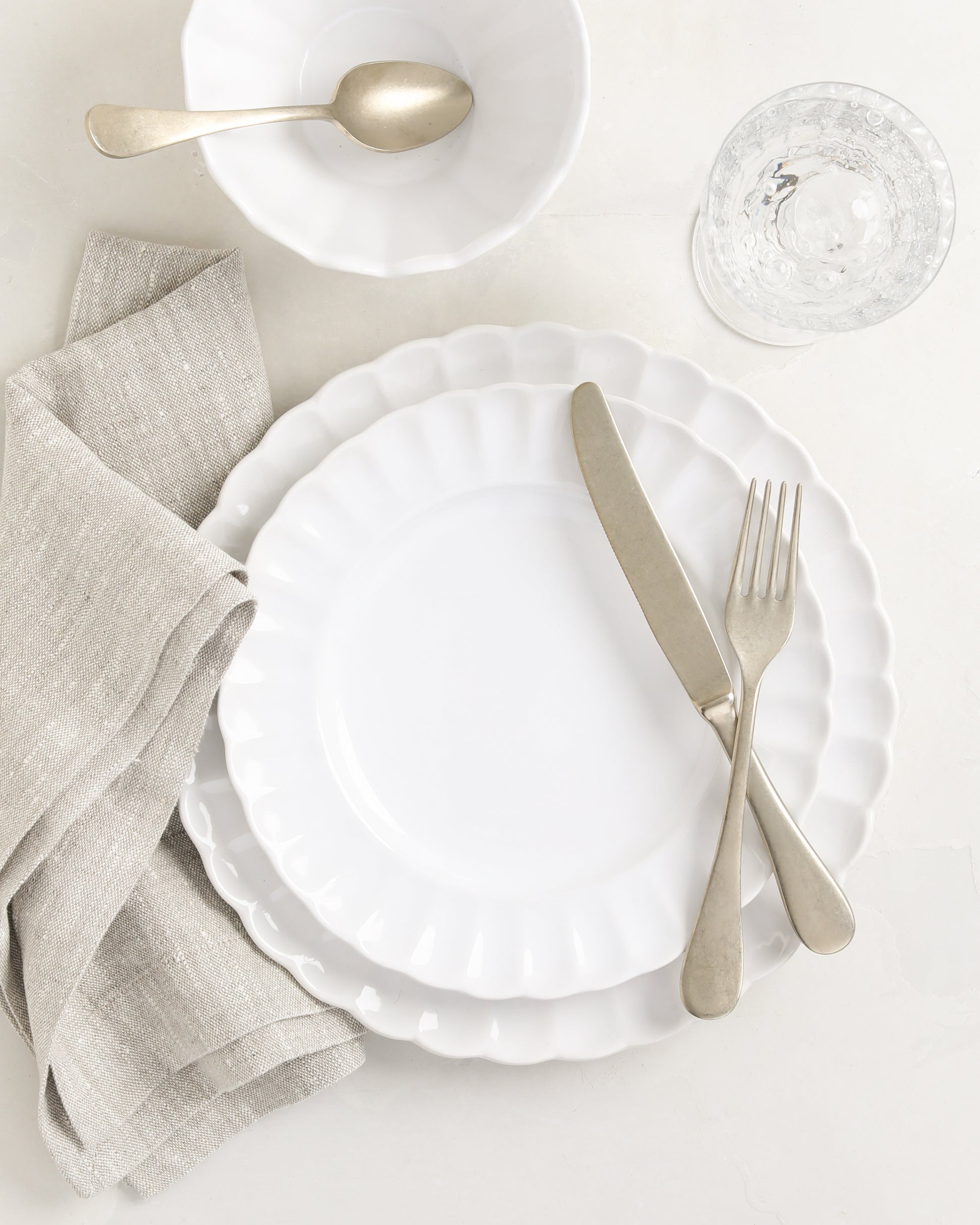 White Petal Stoneware Dinner Plate, 11.25" diameter, with matching salad plate, bowl, and silverware.