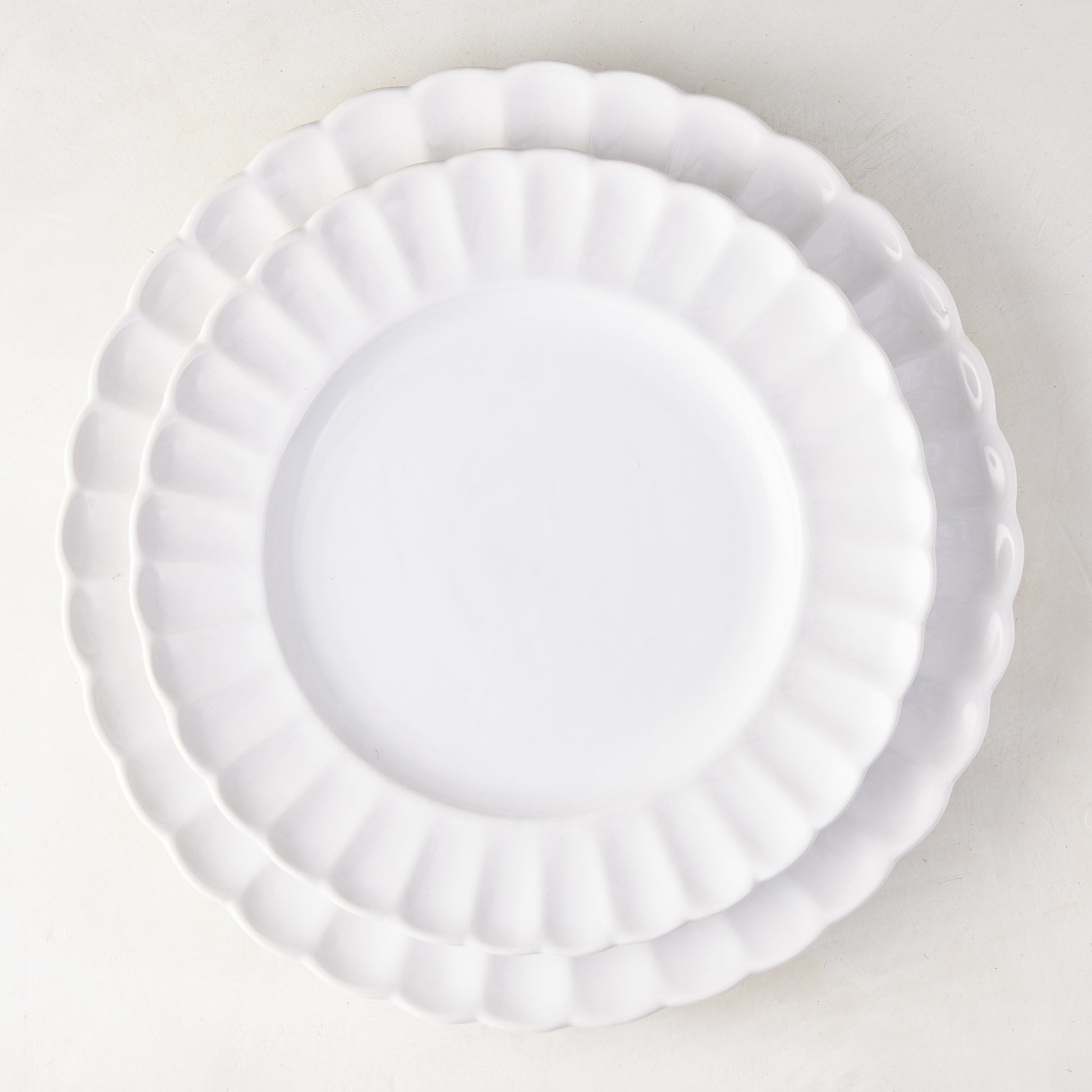 Two white Petal Stoneware Dinner Plates, 11.25" diameter, with scalloped edges, stacked on a white surface.