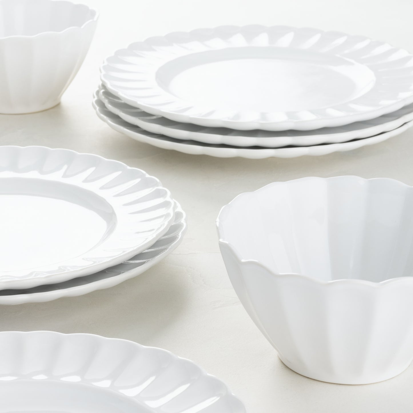 White Petal Stoneware Dinner Plates and Bowls with scalloped edges, glazed ceramic, 11.25" diameter.