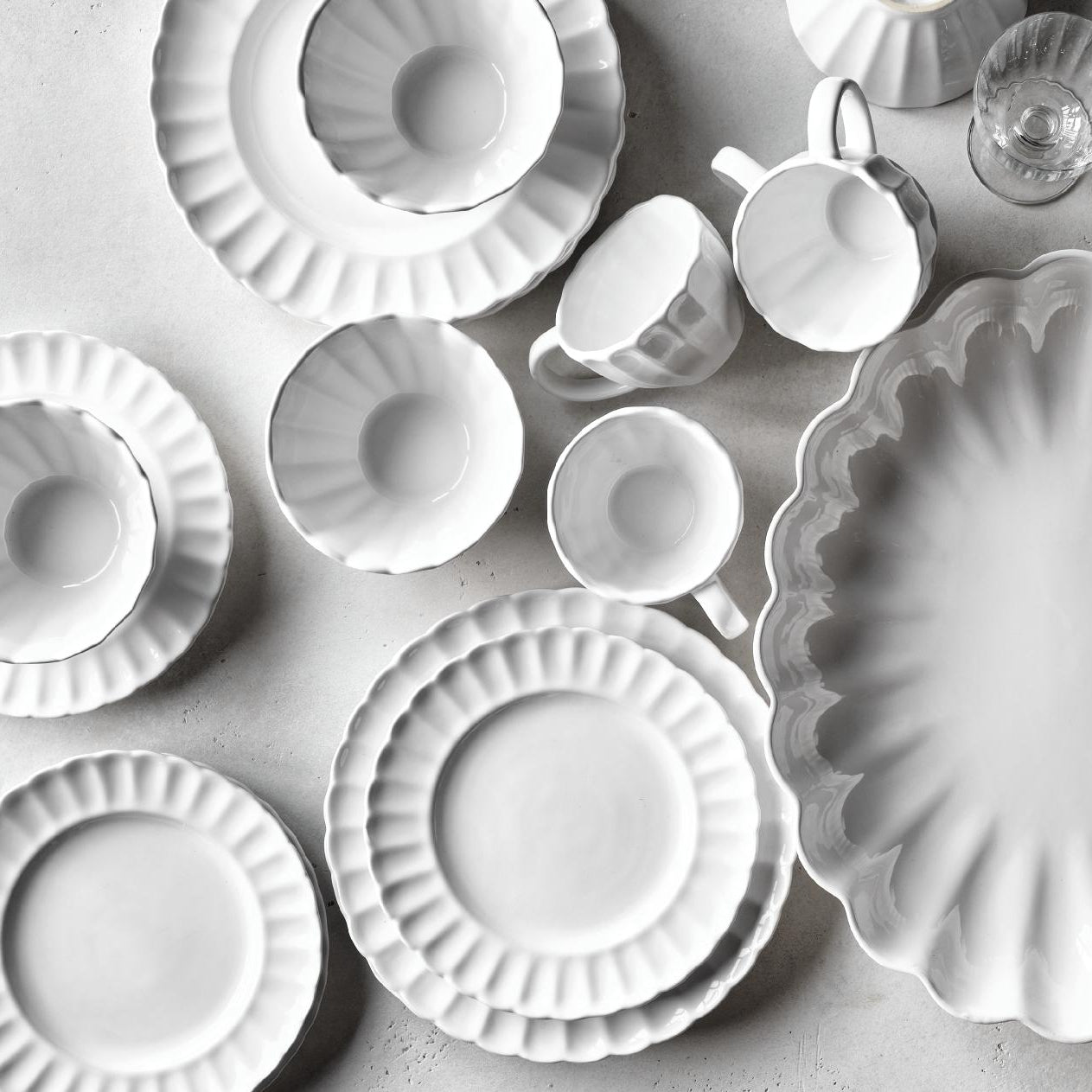 White Petal stoneware mug with a vintage-inspired scalloped edge and glazed ceramic finish, viewed from above.