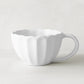 White Petal Stoneware Mug, 11.83oz, with rounded edges and vintage-inspired scalloped design.