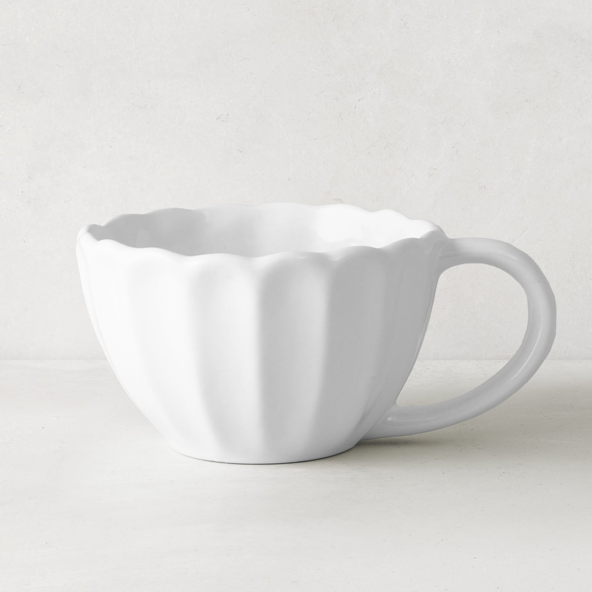 White Petal Stoneware Mug, 11.83oz, with rounded edges and vintage-inspired scalloped design.