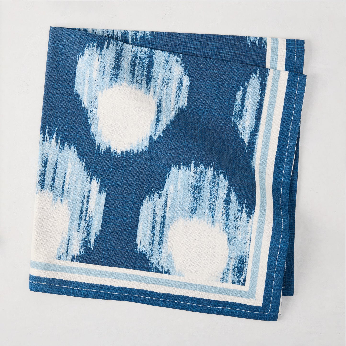 Peter Dunham + Hudson Grace Blue Bukhara Ikat Printed Napkin, 100% cotton slub, folded.