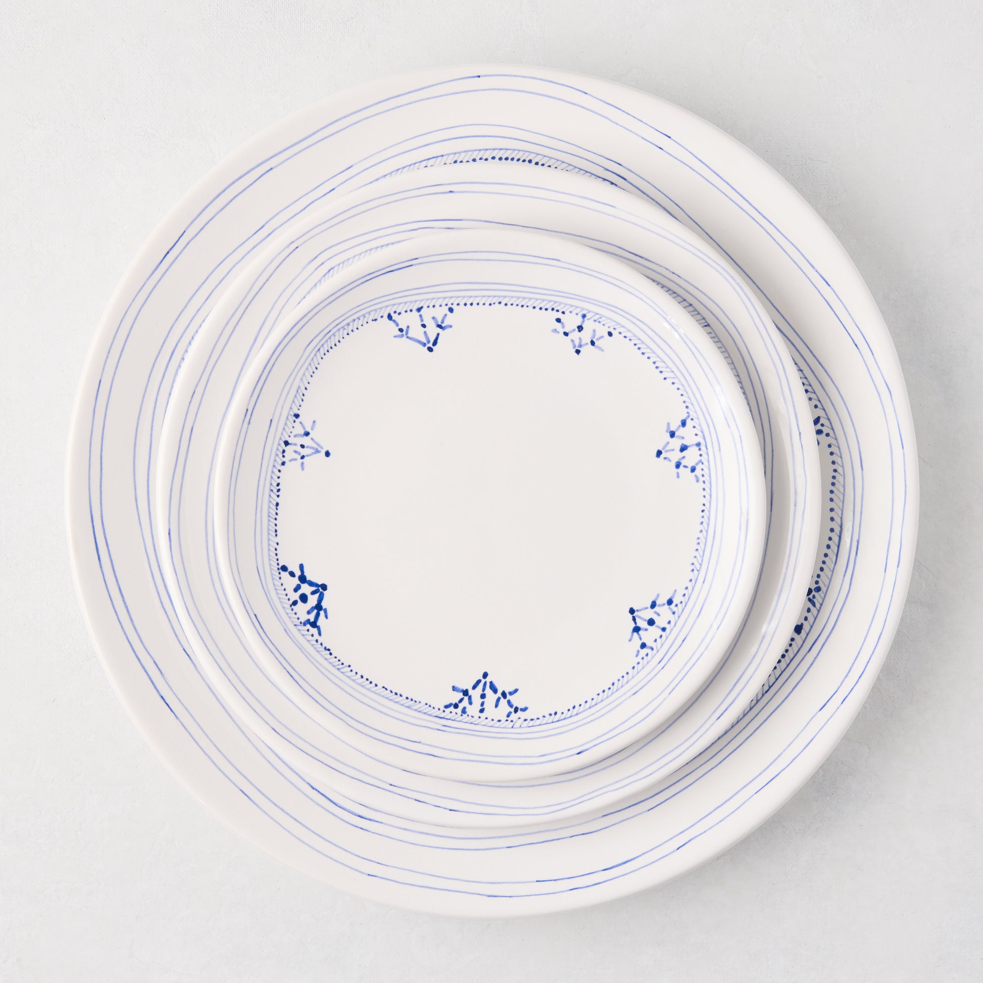 Peter Dunham + Hudson Grace Blue Fez hand-painted border appetizer plate, white with blue lines and dots.