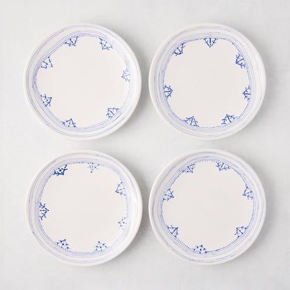 Four white Peter Dunham + Hudson Grace Blue Fez hand-painted border appetizer plates.