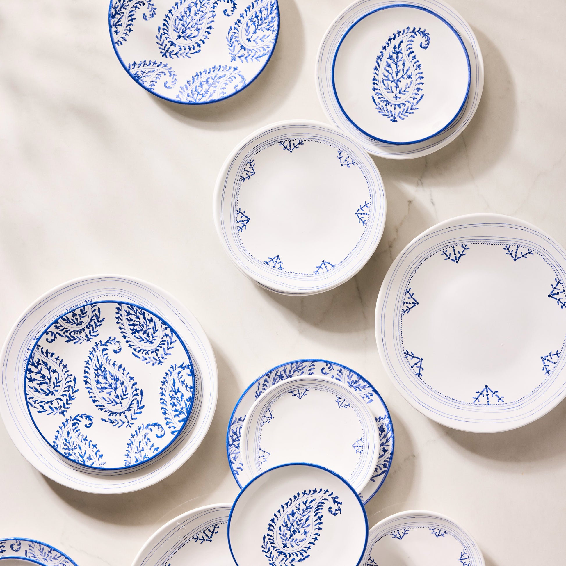 Peter Dunham + Hudson Grace Blue Fez appetizer plates with hand-painted paisley and border patterns on white.