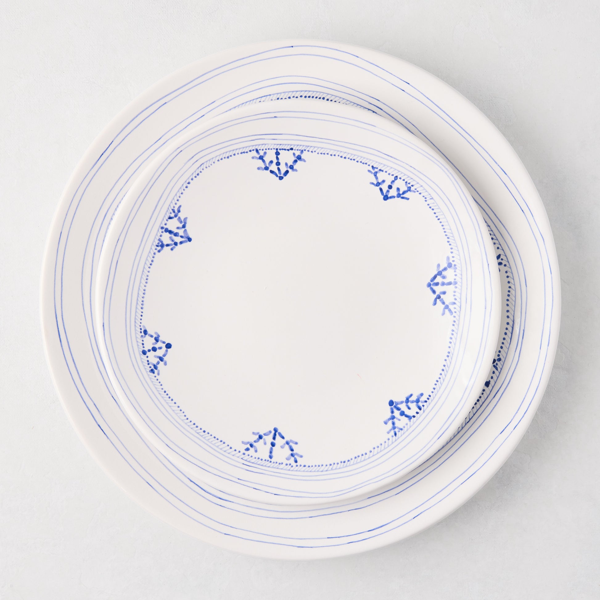 Peter Dunham + Hudson Grace Blue Fez hand-painted ceramic dinner plate with a blue border design.