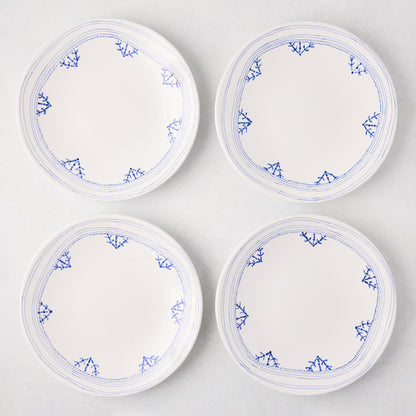 Four white Peter Dunham + Hudson Grace Blue Fez hand-painted border salad plates with blue patterns.