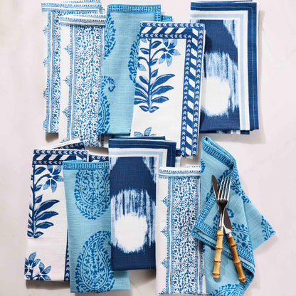 Peter Dunham + Hudson Grace Blue Fez Stripe cotton slub napkin with various blue patterned napkins and bamboo flatware.