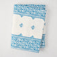 Peter Dunham + Hudson Grace Blue Fez Stripe 100% cotton slub tablecloth, folded, with intricate blue pattern.