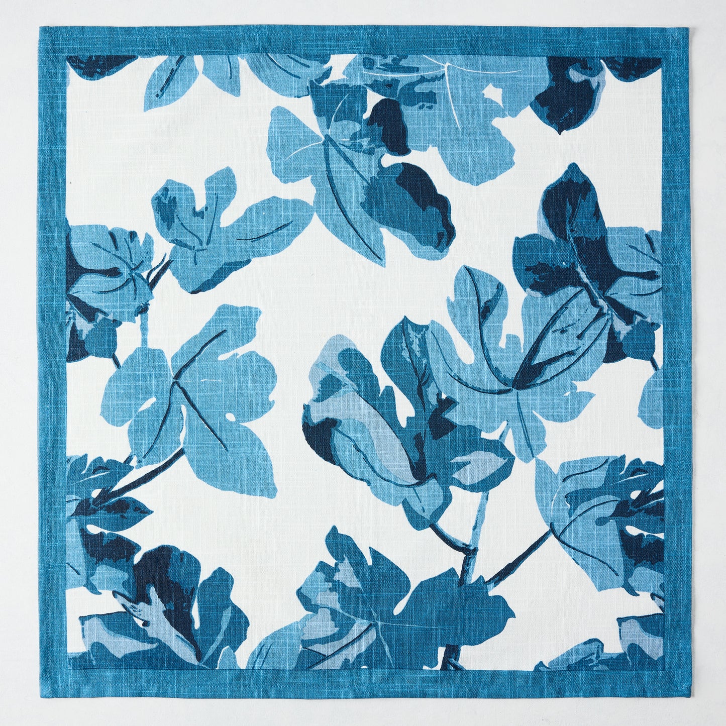 Peter Dunham + Hudson Grace Blue Fig Leaf Printed White Napkin, 100% cotton slub with blue border.