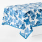 Peter Dunham blue fig leaf print cotton tablecloth with blue border on white background.