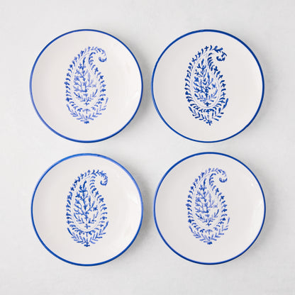 Four white Peter Dunham + Hudson Grace Blue Hand-Painted Kashmir Paisley Appetizer Plates with blue rims.