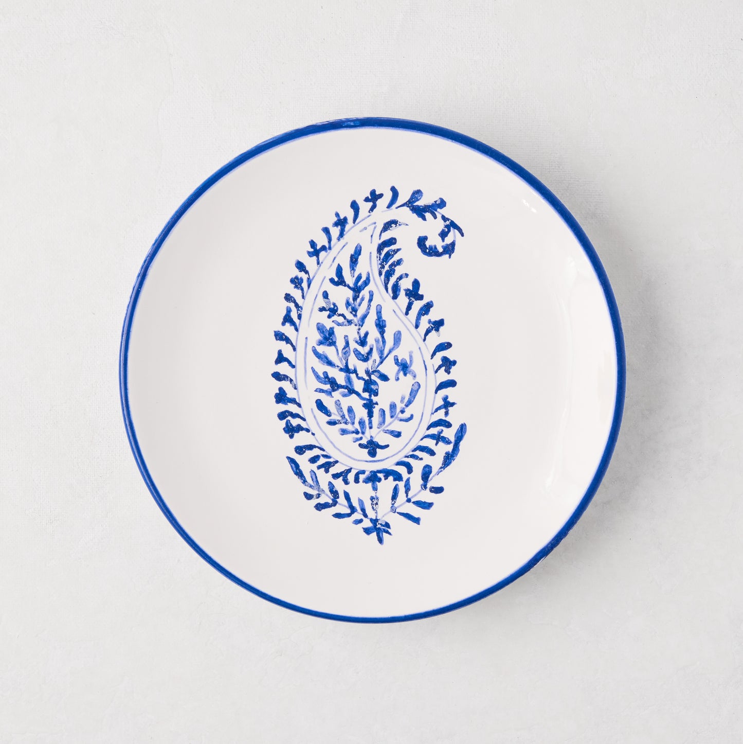 Peter Dunham + Hudson Grace blue hand-painted Kashmir paisley appetizer plate, white ceramic with blue rim.