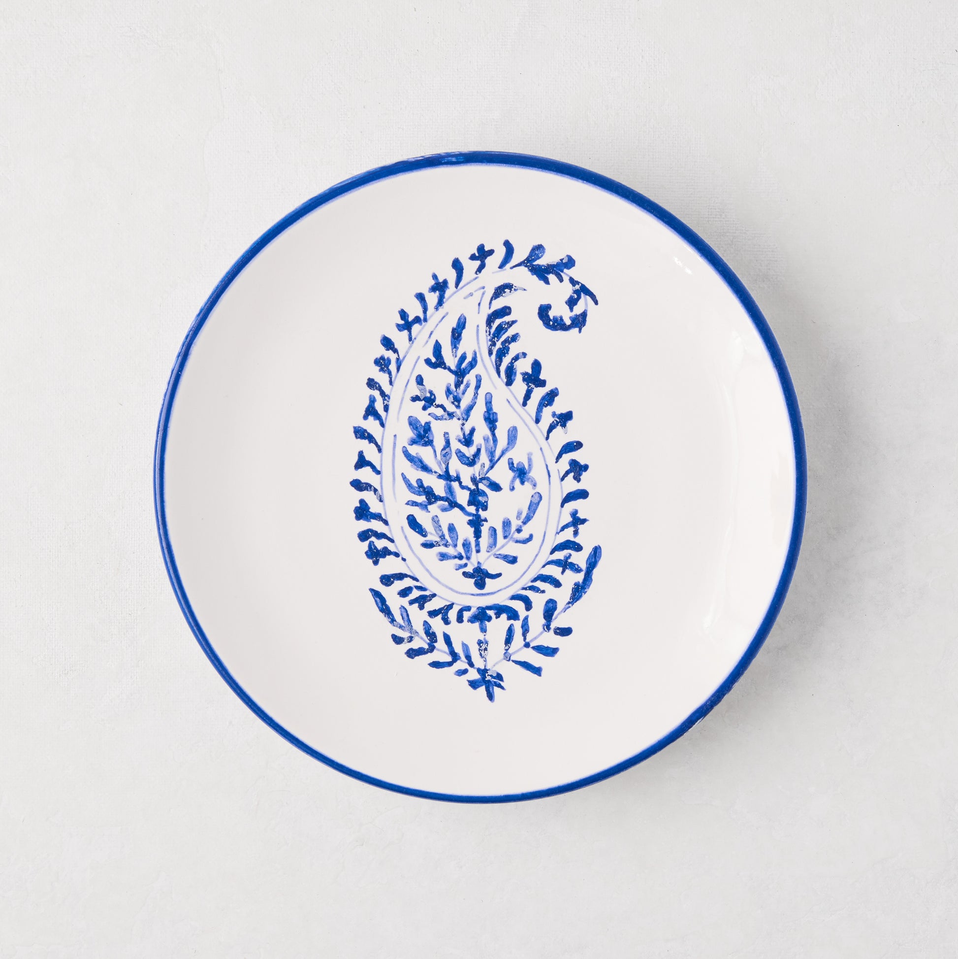 Peter Dunham + Hudson Grace blue hand-painted Kashmir paisley appetizer plate, white ceramic with blue rim.