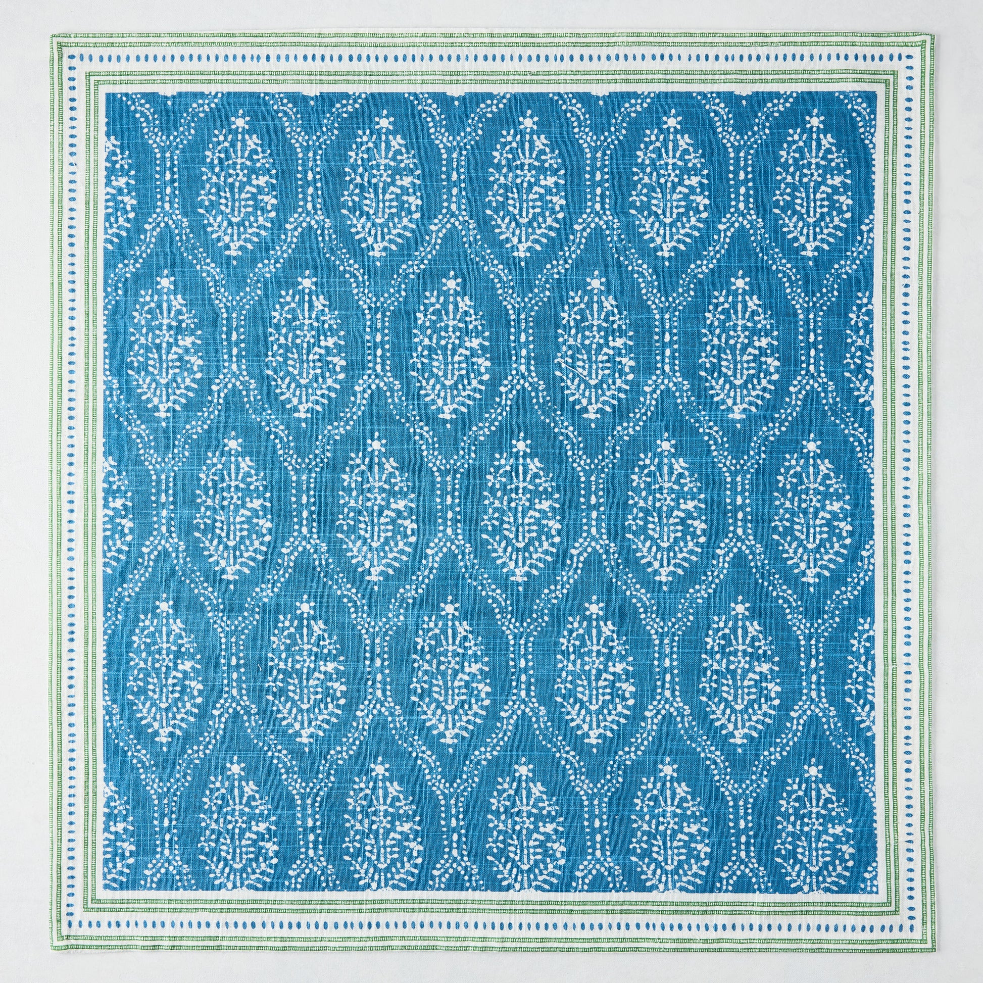 Peter Dunham + Hudson Grace Blue Jaali Printed Napkin, 100% cotton slub with green border.