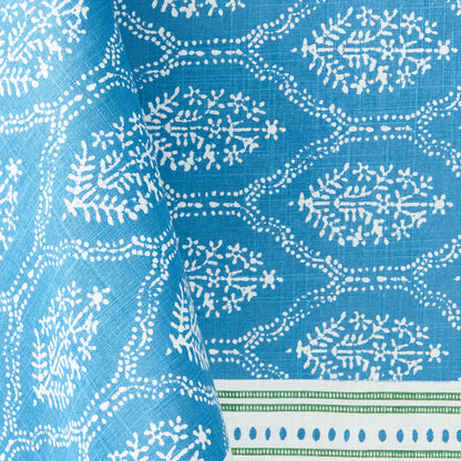 Blue Jaali printed cotton tablecloth with white floral pattern and green border detail.